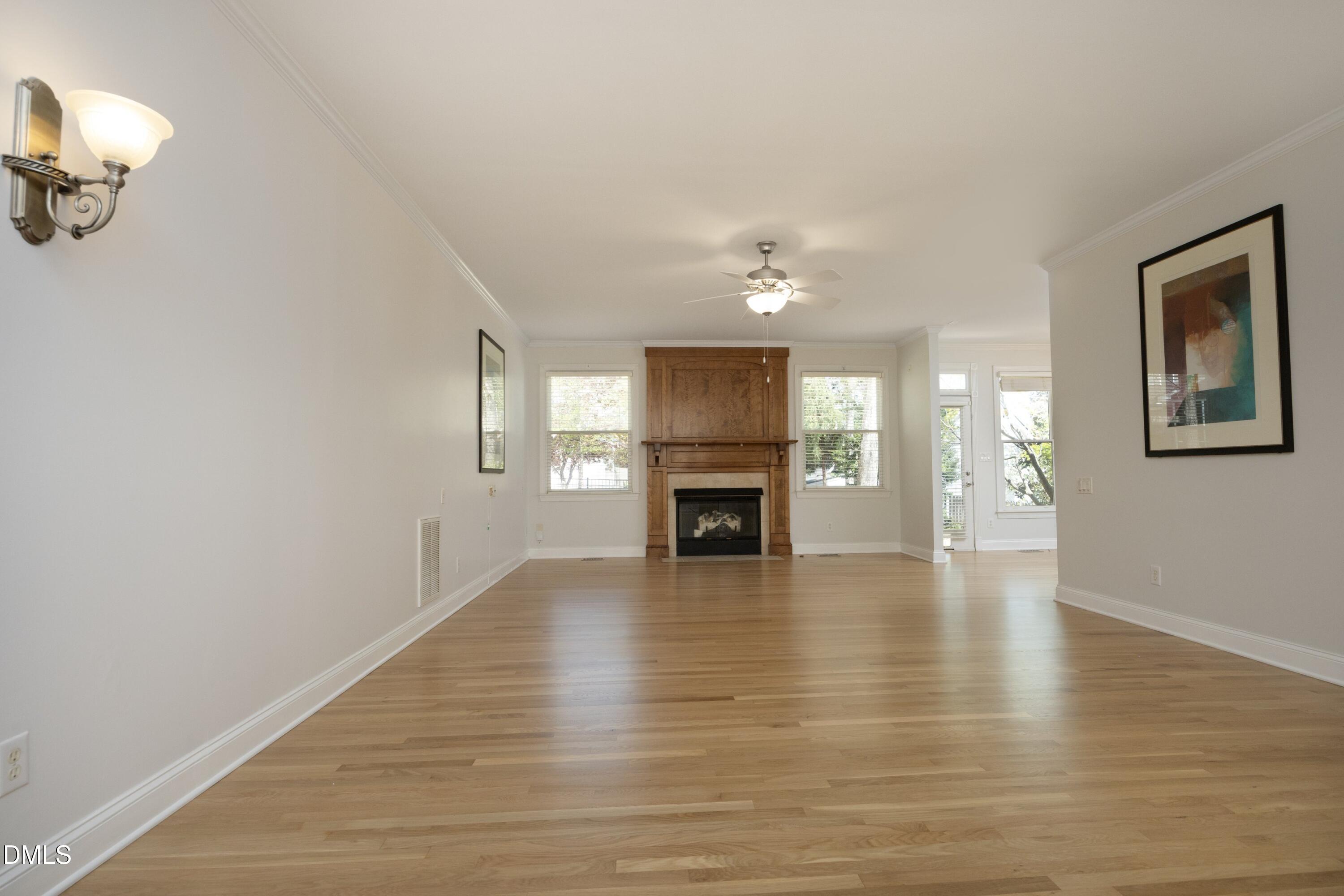 1427 Moosecreek Drive Raleigh, NC 27614 - Photo 9 of 48 a view of an empty room with a fireplace and wooden floor