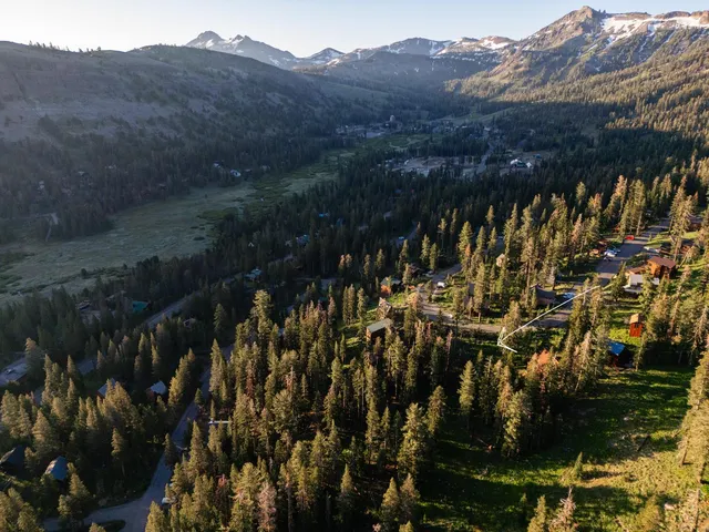 a view of a mountain range with trees in the background