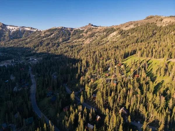 a view of a lush green hillside and houses