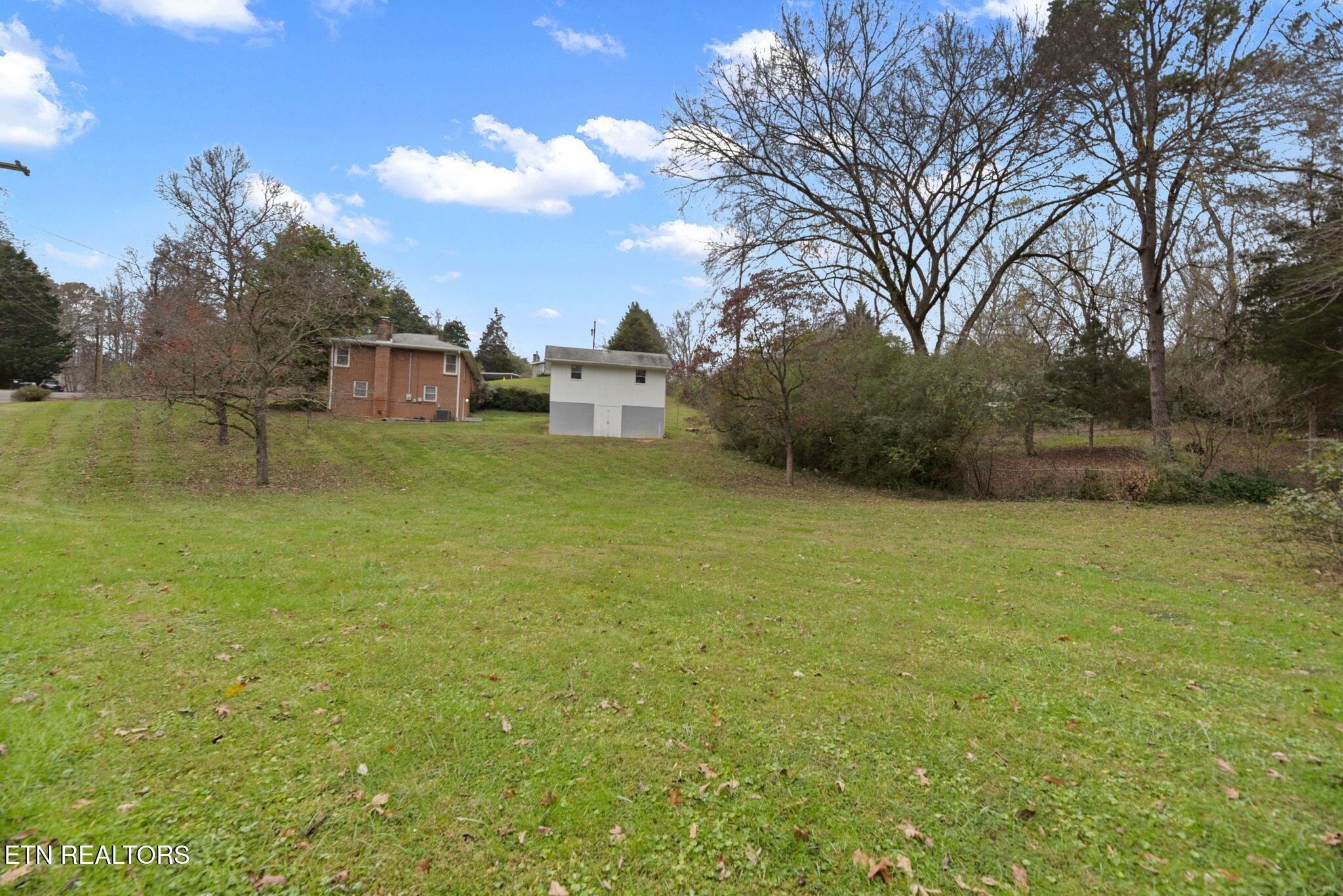 352 Walnut Valley Road Clinton, TN 37716 - Photo 32 of 36 a view of a yard with a house in the background