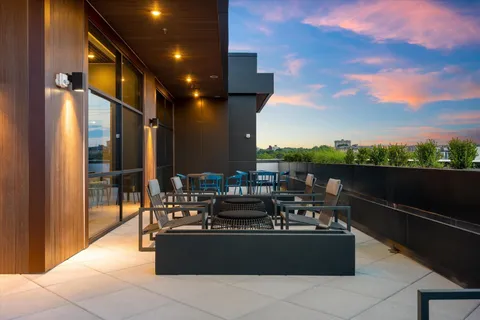 a view of a roof deck with furniture