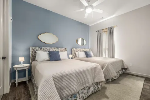 a bedroom with bed and wooden floor