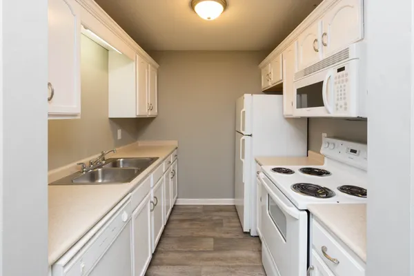 a kitchen with stainless steel appliances a sink a stove and a refrigerator