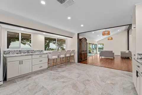 a view of a hallway with wooden floor and closet