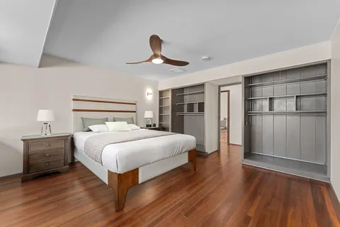 a view of empty room with wooden floor