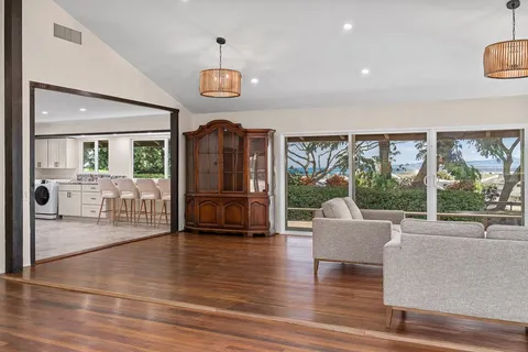 a living room with furniture and large windows
