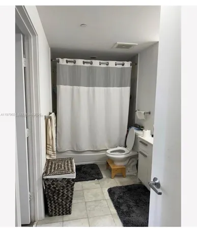 a bathroom with a toilet a sink and a mirror
