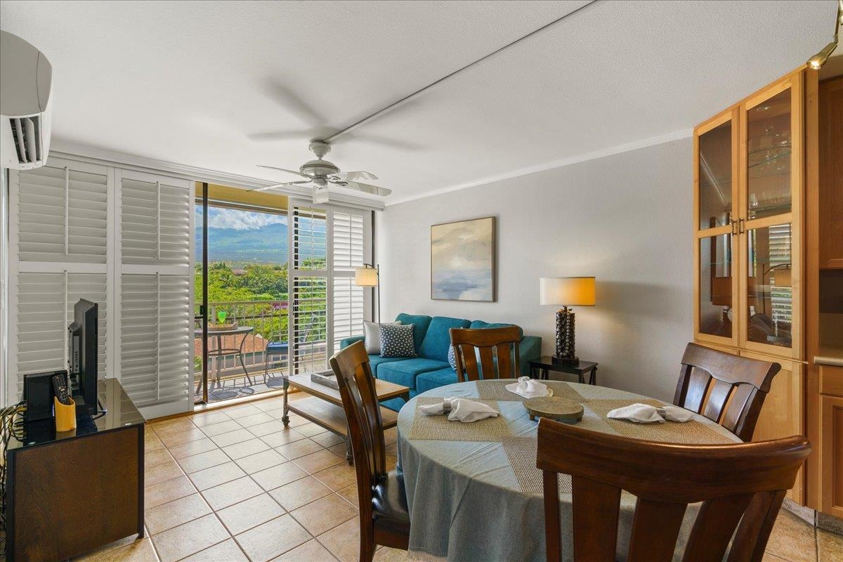 2219 South Kihei Road, Unit B414 Kihei, HI 96753 - Photo 2 of 42 a living room with furniture a large window and a chandelier