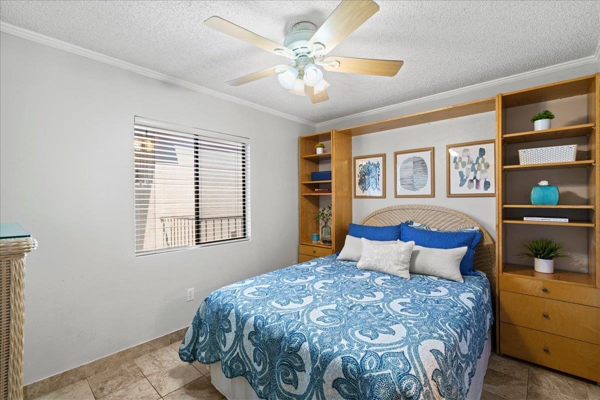 2219 South Kihei Road, Unit B414 Kihei, HI 96753 - Photo 25 of 42 a bedroom with a large bed and a chandelier