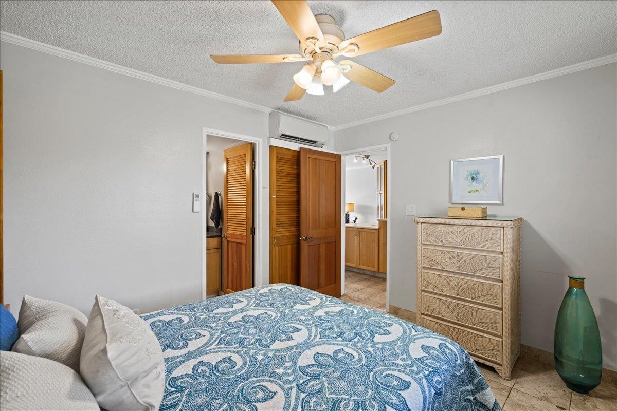 2219 South Kihei Road, Unit B414 Kihei, HI 96753 - Photo 27 of 42 a bedroom with a bed and a dresser