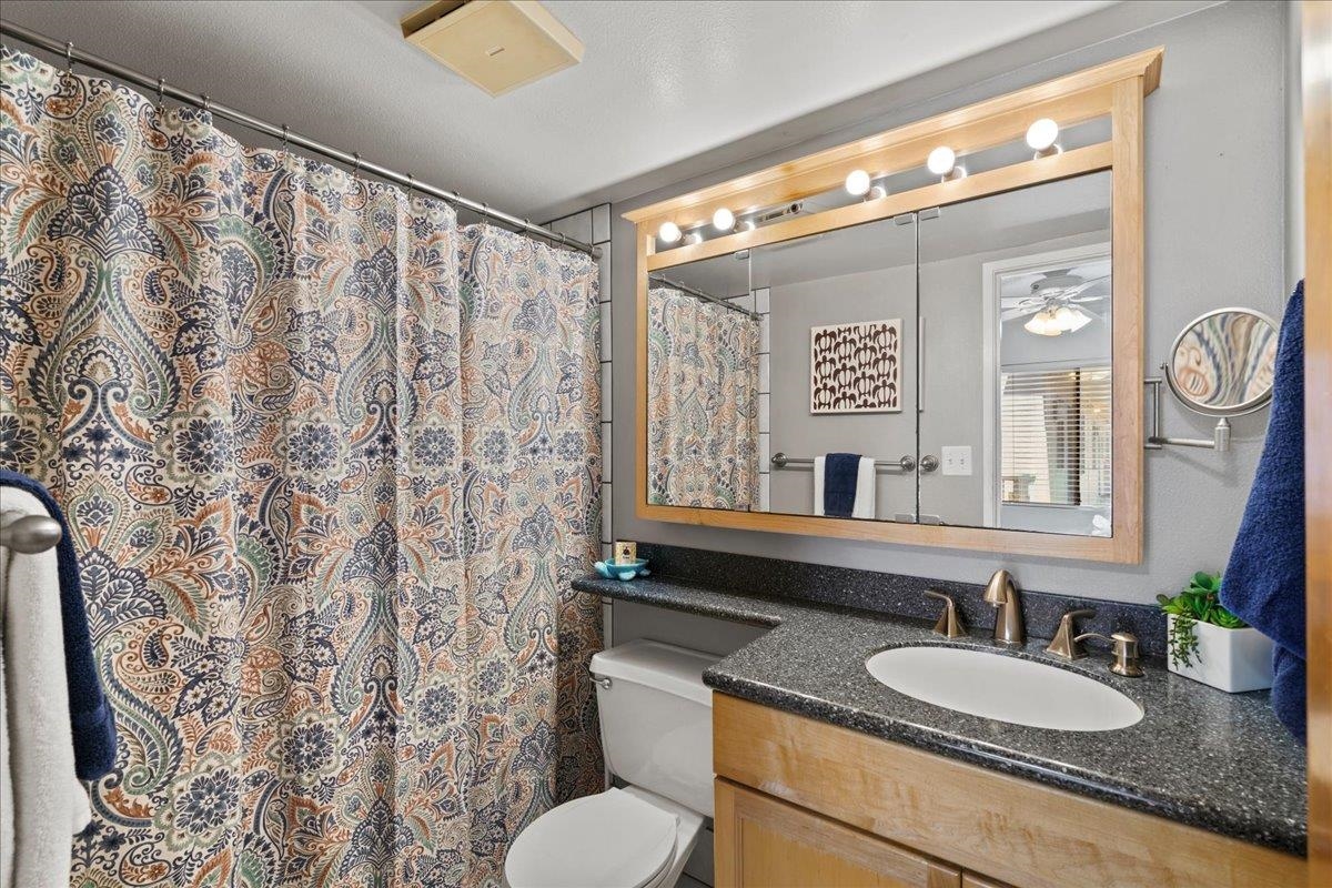 2219 South Kihei Road, Unit B414 Kihei, HI 96753 - Photo 4 of 42 a bathroom with a granite countertop sink and a mirror