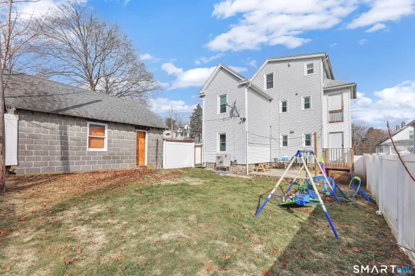 a view of a white house with large windows