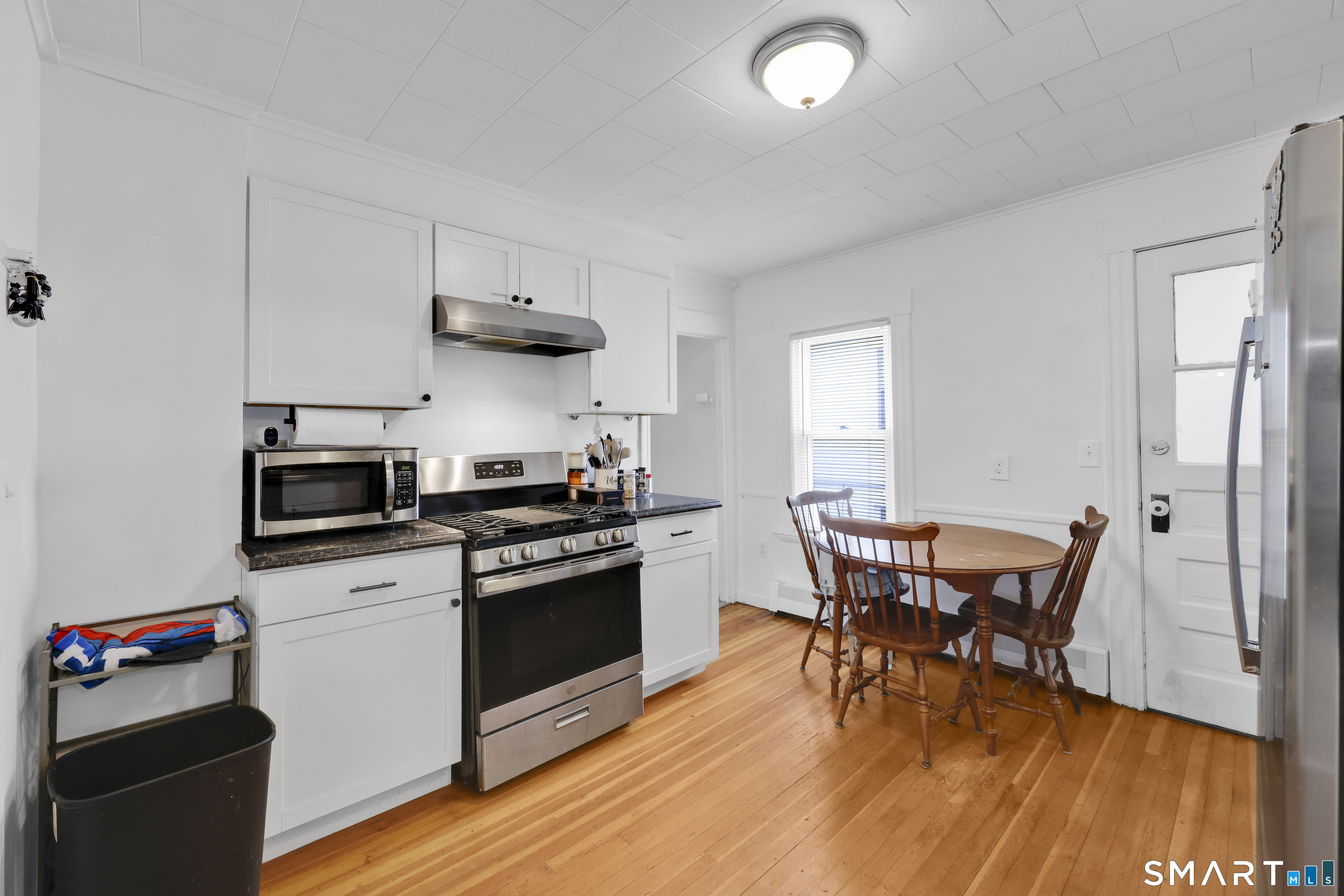 169 Central Avenue Torrington, CT 06790 - Photo 17 of 31 a kitchen with stainless steel appliances a stove a sink a dining table and chairs