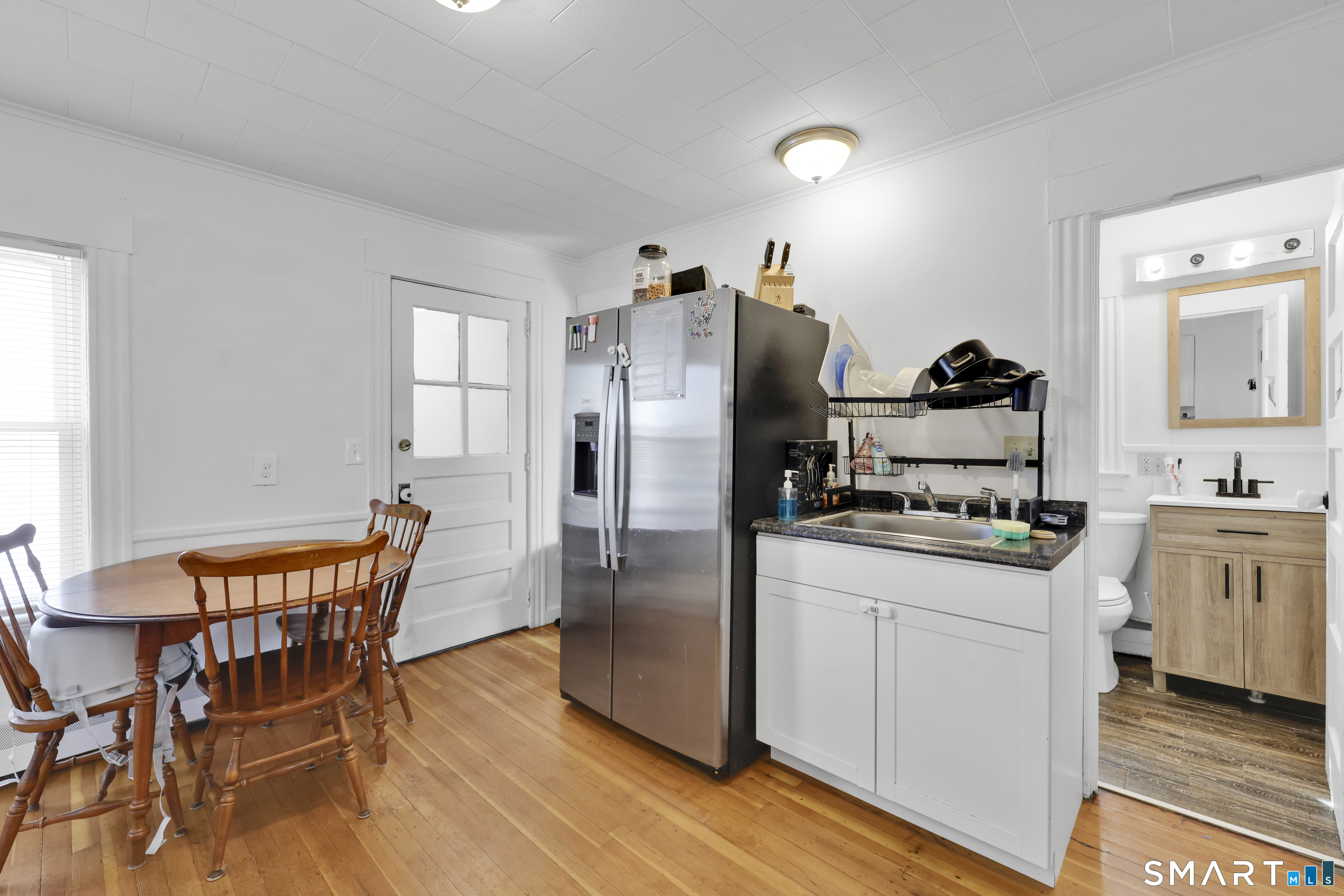 169 Central Avenue Torrington, CT 06790 - Photo 18 of 31 a kitchen with stainless steel appliances kitchen island granite countertop a refrigerator a stove a dining table and chairs