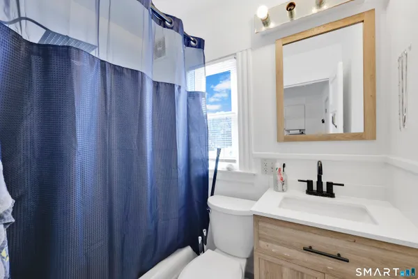 a kitchen with stainless steel appliances a stove a sink a dining table and chairs