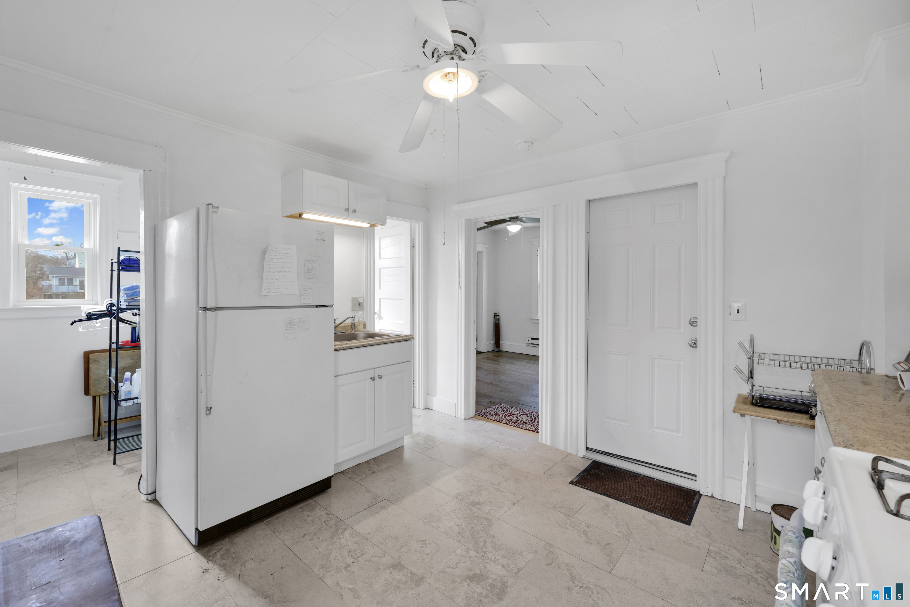 169 Central Avenue Torrington, CT 06790 - Photo 22 of 31 a view of a kitchen with refrigerator and cabinets