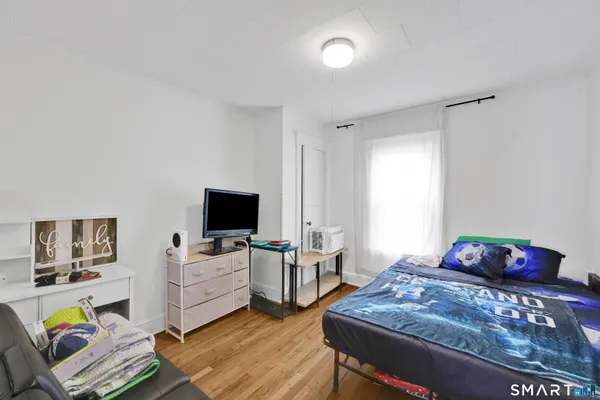 a view of a kitchen with refrigerator and cabinets