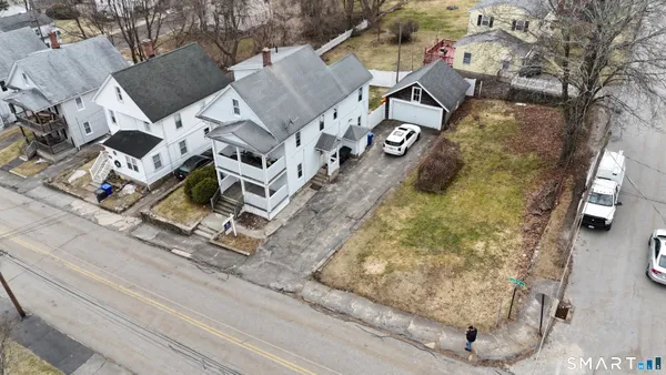 an aerial view of a house with a yard