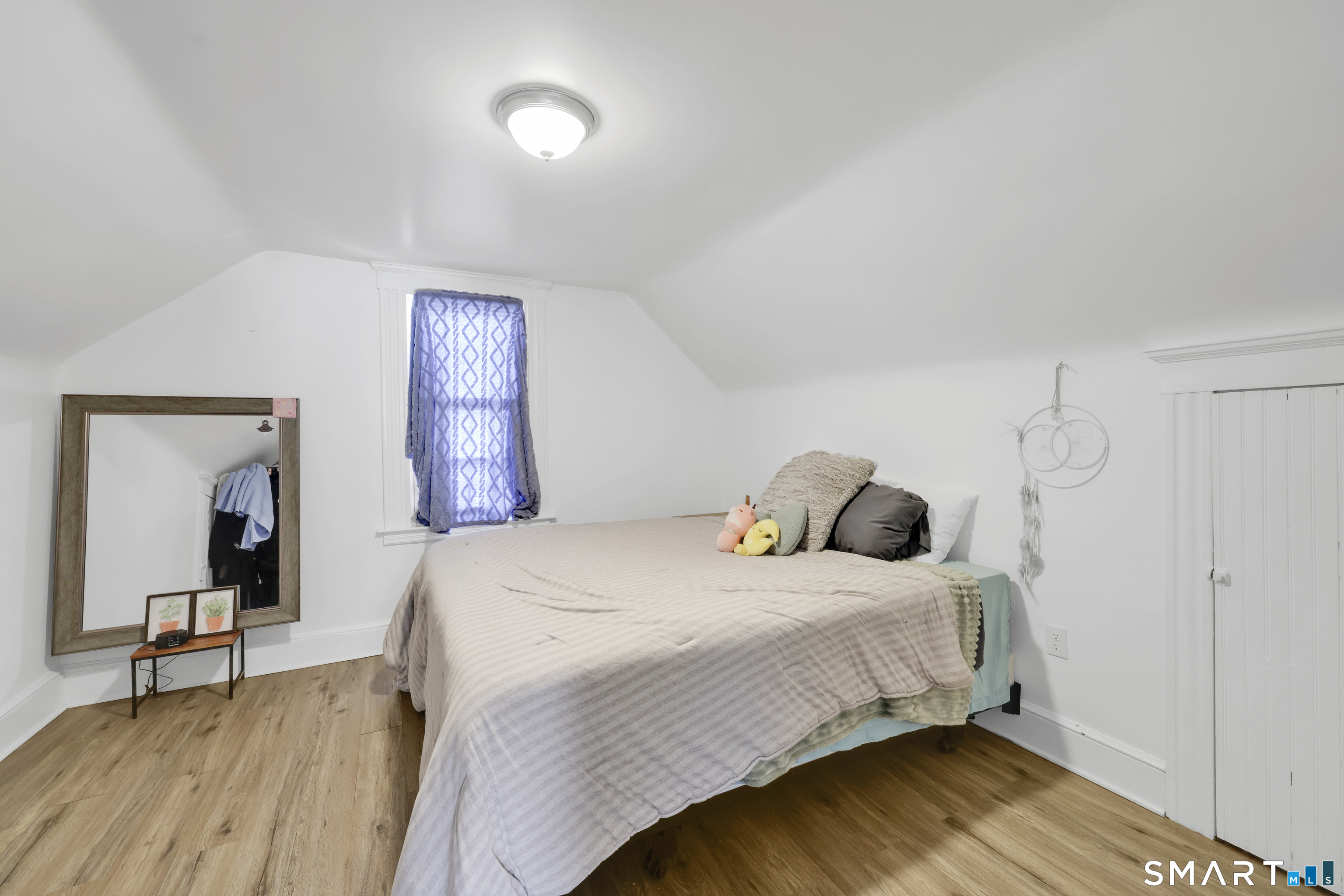 169 Central Avenue Torrington, CT 06790 - Photo 31 of 31 a bedroom with a bed and wooden floor