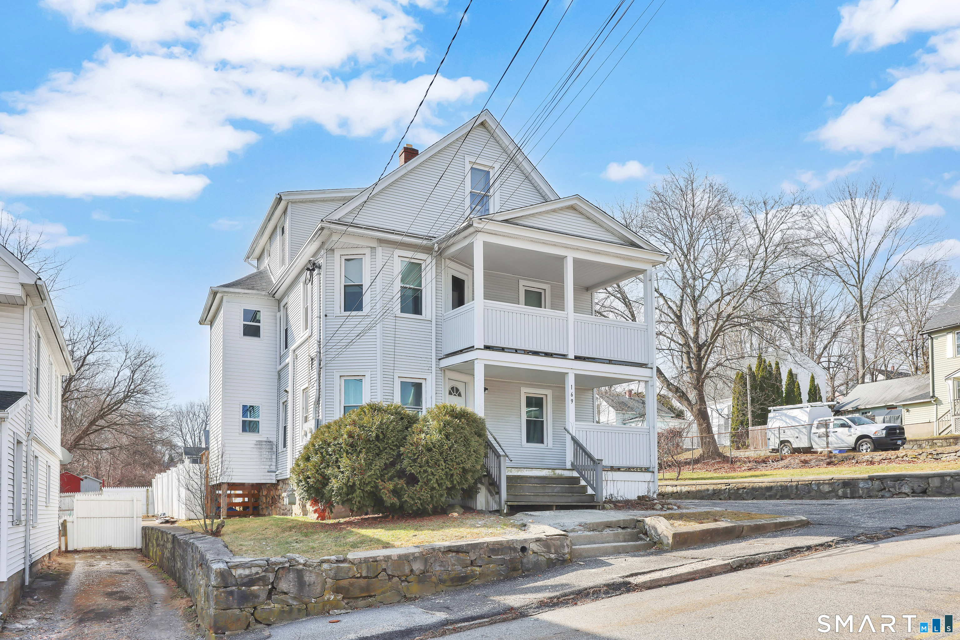 169 Central Avenue Torrington, CT 06790 - Photo 10 of 31 a view of a white house next to a road and yard