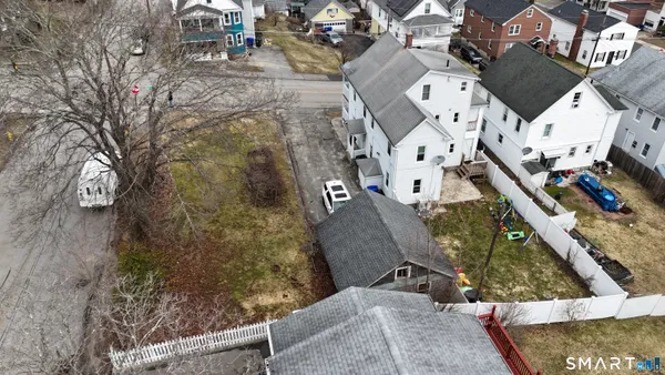 an aerial view of residential houses with outdoor space