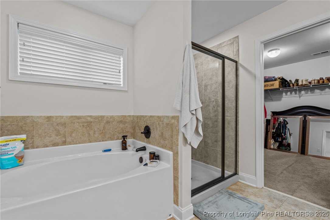 182 Valley Stream Road Spring Lake, NC 28390 - Photo 15 of 26 a bathroom with a bathtub and a shower