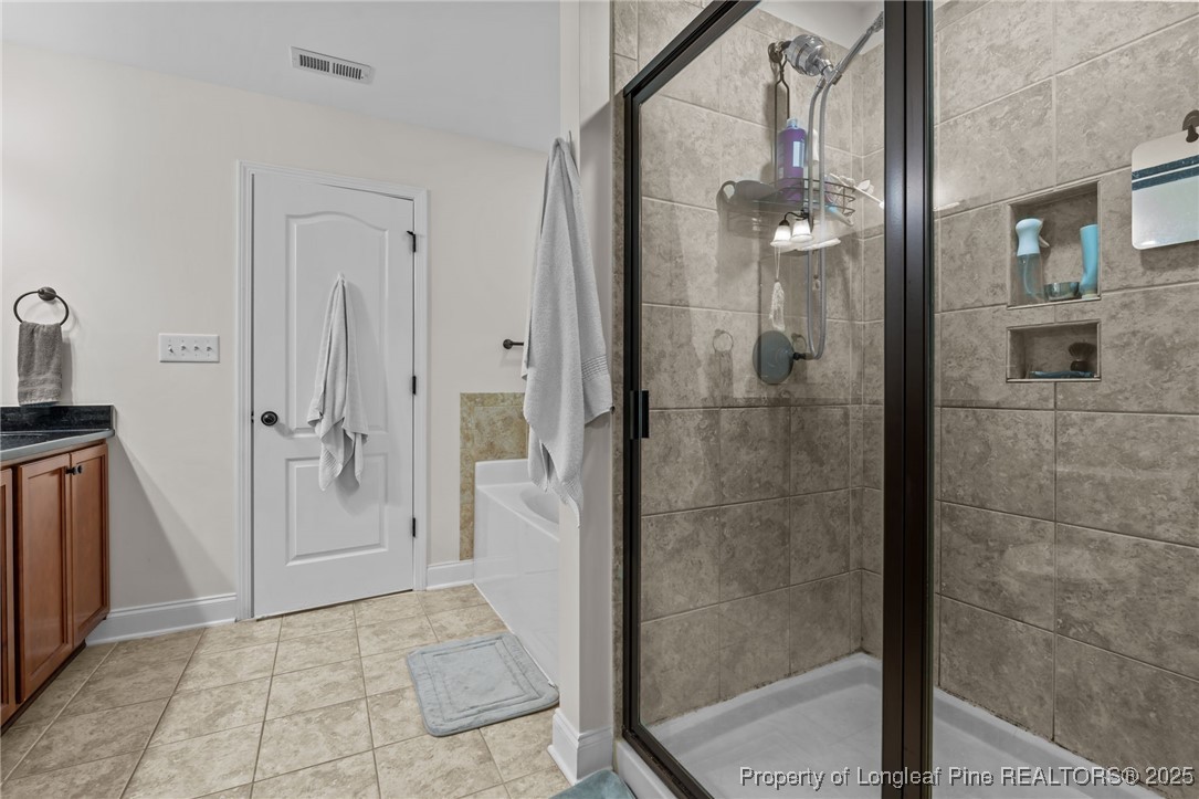 182 Valley Stream Road Spring Lake, NC 28390 - Photo 16 of 26 a bathroom with a glass shower door