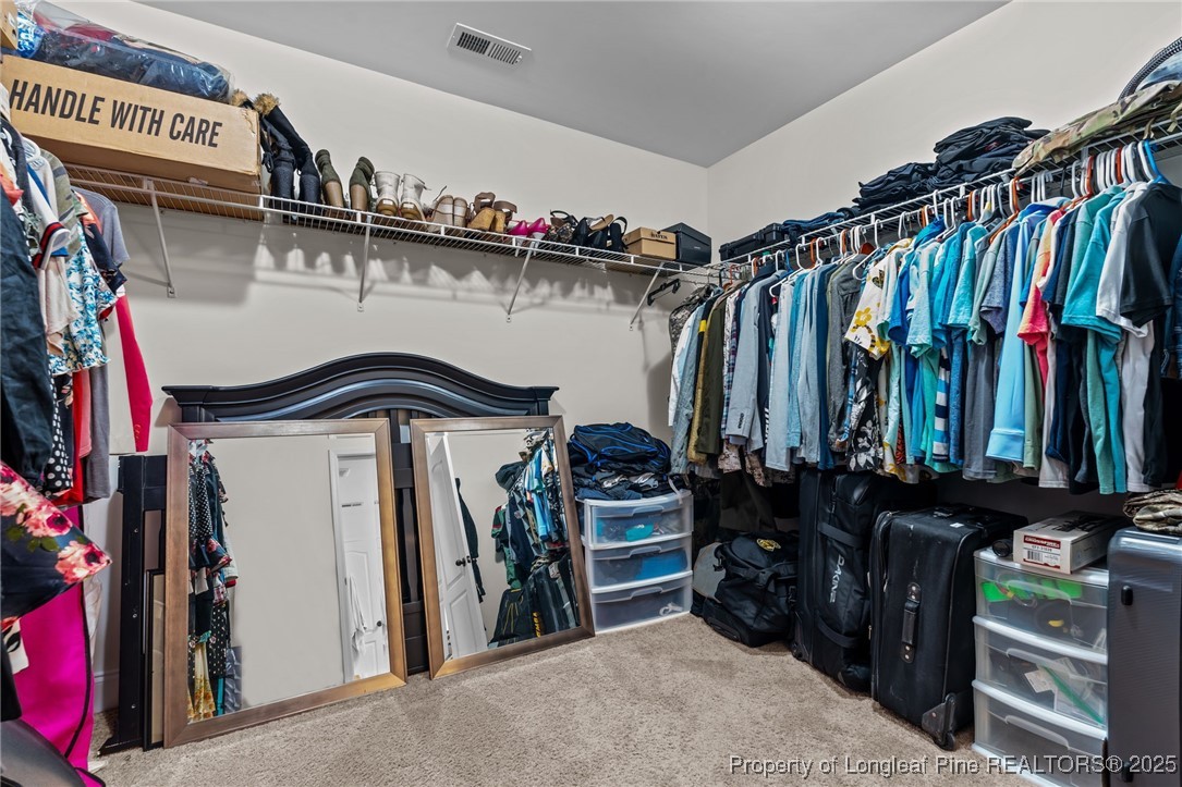 182 Valley Stream Road Spring Lake, NC 28390 - Photo 17 of 26 a view of walk in closet with clothes and shoes