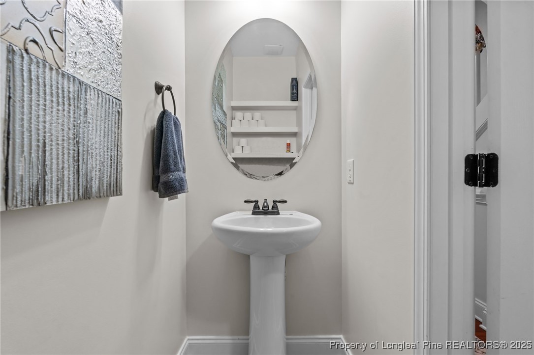 182 Valley Stream Road Spring Lake, NC 28390 - Photo 7 of 26 a bathroom with a sink and a mirror