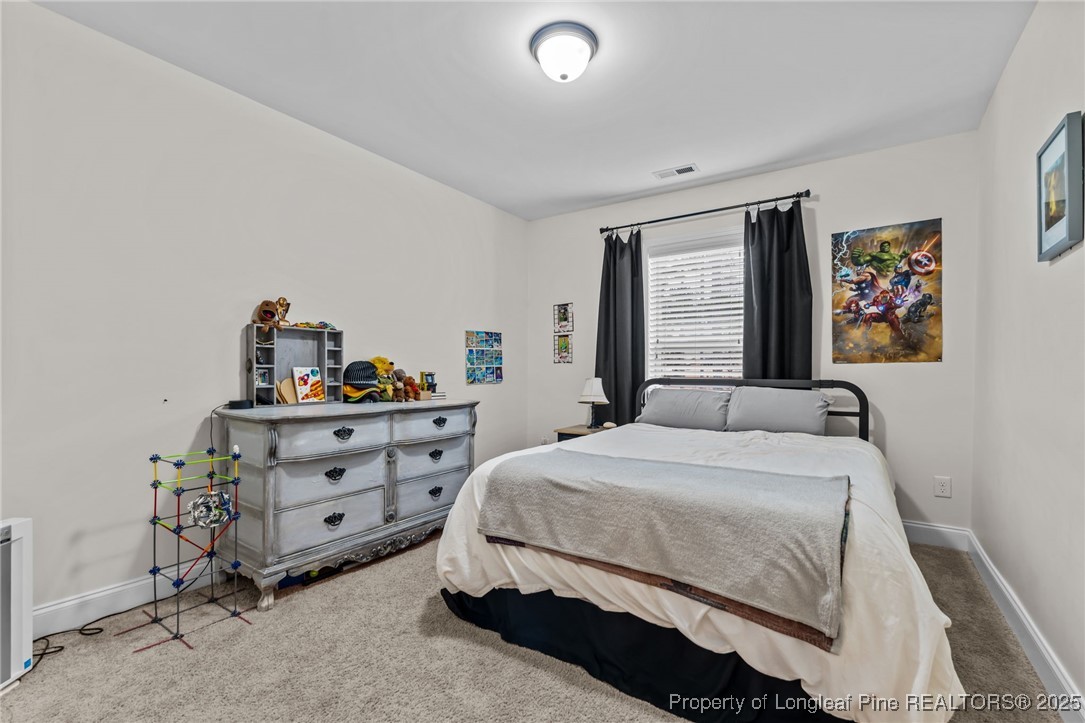 182 Valley Stream Road Spring Lake, NC 28390 - Photo 9 of 26 a bedroom with a bed and furniture
