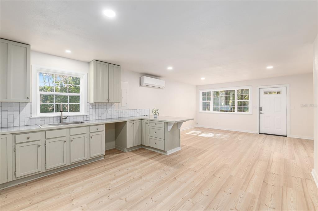 18124 Southwest 75 Avenue Archer, FL 32618 - Photo 12 of 52 a large kitchen with stainless steel appliances granite countertop a sink and dishwasher with wooden floor