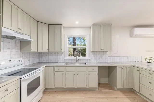 a kitchen with a sink stove and cabinets