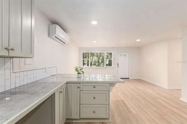 a kitchen with granite countertop white cabinets and a sink
