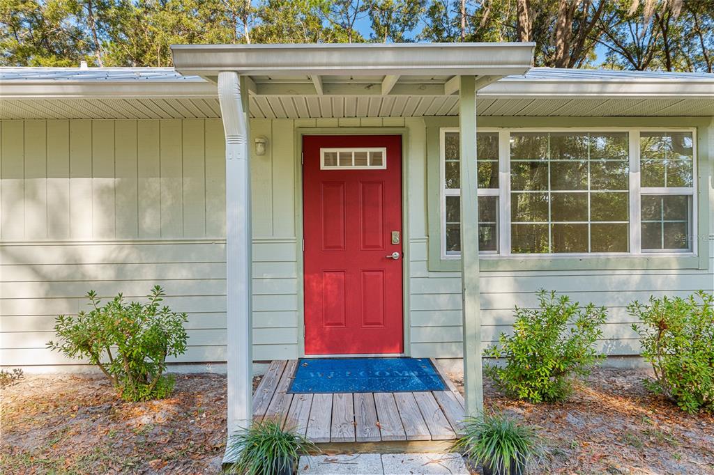 18124 Southwest 75 Avenue Archer, FL 32618 - Photo 2 of 52 a front view of a house with a yard