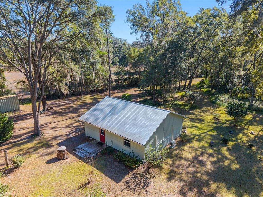 18124 Southwest 75 Avenue Archer, FL 32618 - Photo 28 of 52 a view of a backyard with a small cabin