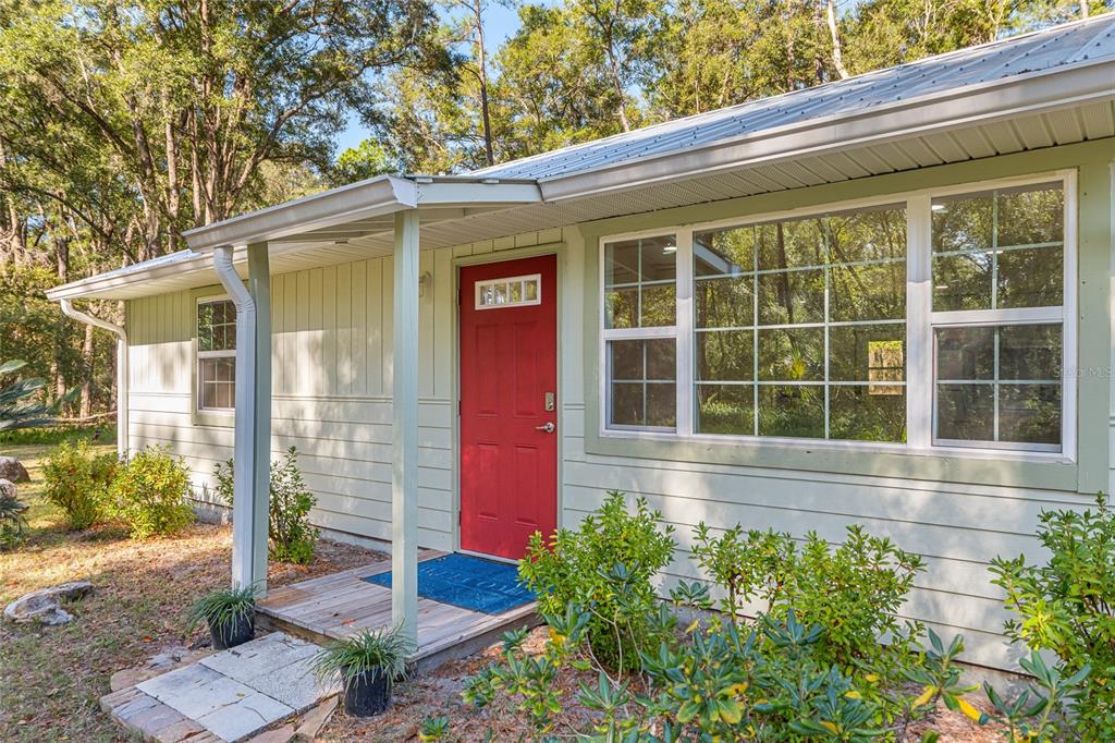 18124 Southwest 75 Avenue Archer, FL 32618 - Photo 3 of 52 a front view of a house with a yard