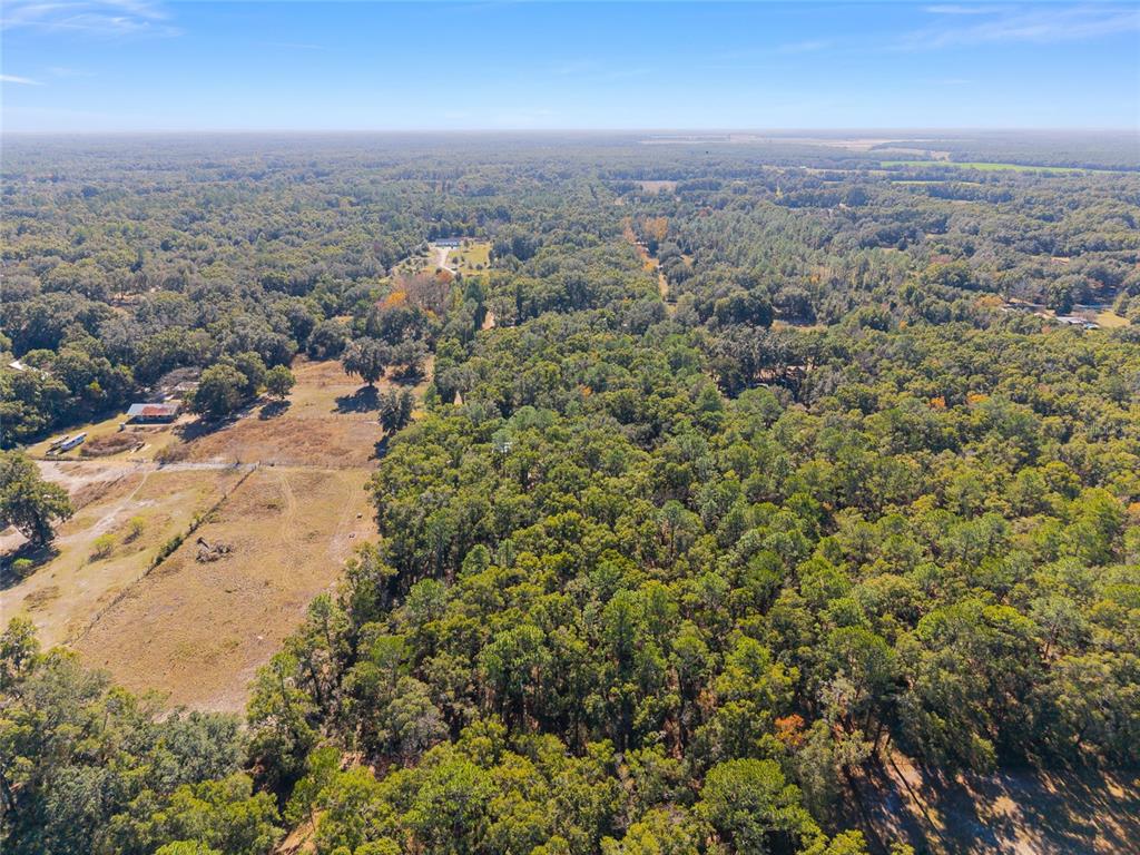 18124 Southwest 75 Avenue Archer, FL 32618 - Photo 34 of 52 an aerial view of house with yard and mountain view in back