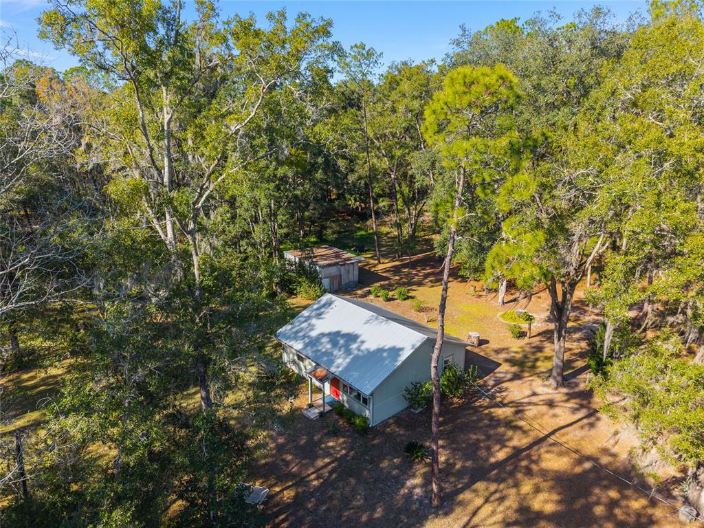 18124 Southwest 75 Avenue Archer, FL 32618 - Photo 35 of 52 a backyard of a house with table and chairs