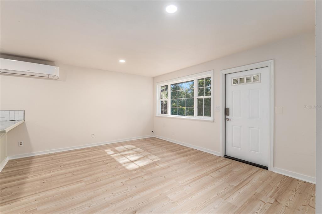 18124 Southwest 75 Avenue Archer, FL 32618 - Photo 8 of 52 an empty room with wooden floor and windows