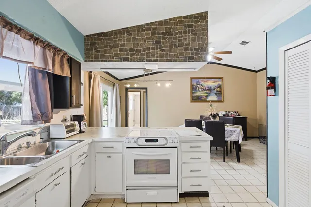 a kitchen with sink cabinets and appliances