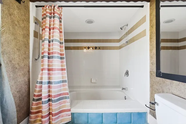 a bathroom with a bathtub and shower