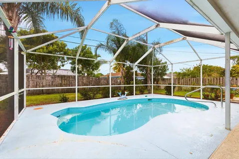 a view of a backyard with swimming pool