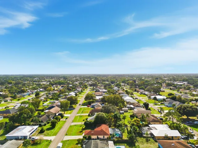 an aerial view of residential houses with city view
