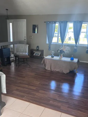 a living room with furniture a window and gym equipment