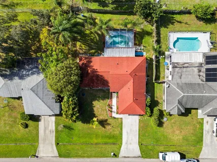 an aerial view of a house with a yard basket ball court and outdoor seating