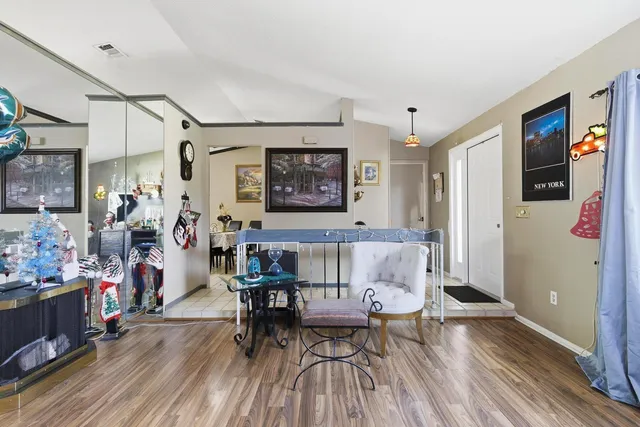 a view of a dining room with furniture and wooden floor