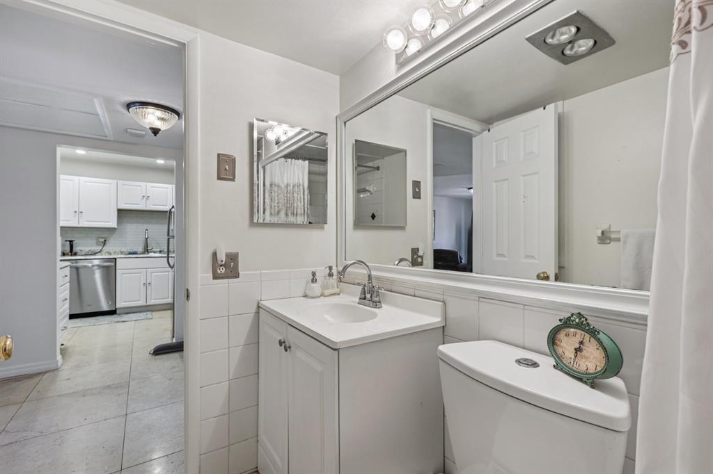 251 South Cypress Road, Unit 120 Pompano Beach, FL 33060 - Photo 14 of 42 a bathroom with a sink a toilet and a mirror