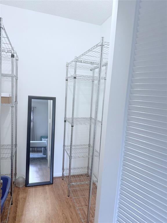 251 South Cypress Road, Unit 120 Pompano Beach, FL 33060 - Photo 18 of 42 a view of an empty room with wooden floor and a bathroom