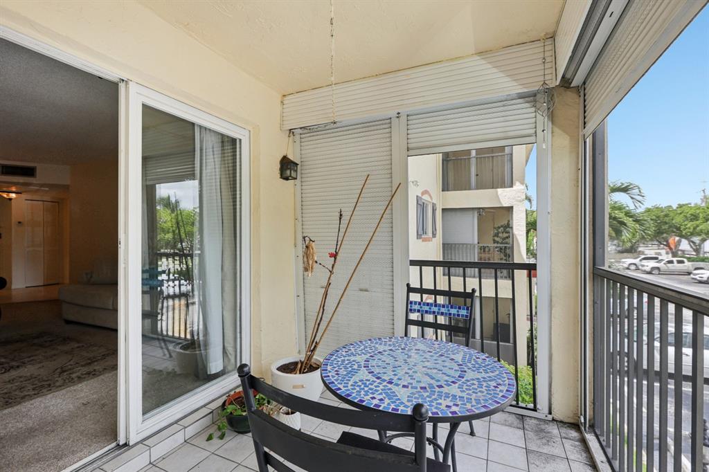 251 South Cypress Road, Unit 120 Pompano Beach, FL 33060 - Photo 20 of 42 a view of porch with seating space and wooden floor