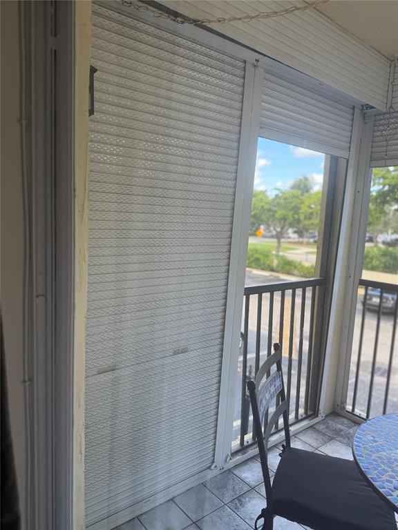 251 South Cypress Road, Unit 120 Pompano Beach, FL 33060 - Photo 21 of 42 a view of a porch with a table and chairs